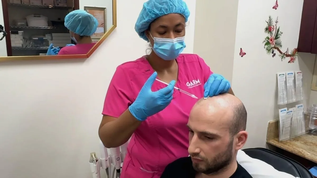 A nurse at GARM Clinic administering a scalp microinjection